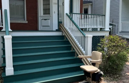 Outdoor stairlift for a porch with green painted stairs